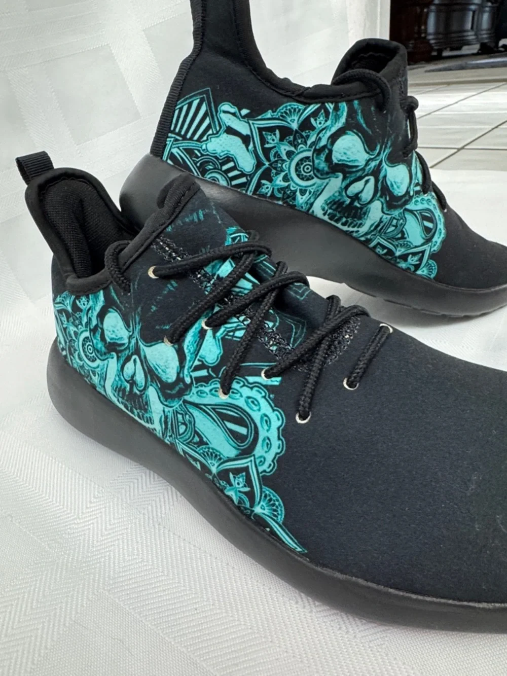 Unisex Black Lightweight Sneakers with Teal Skull Accent